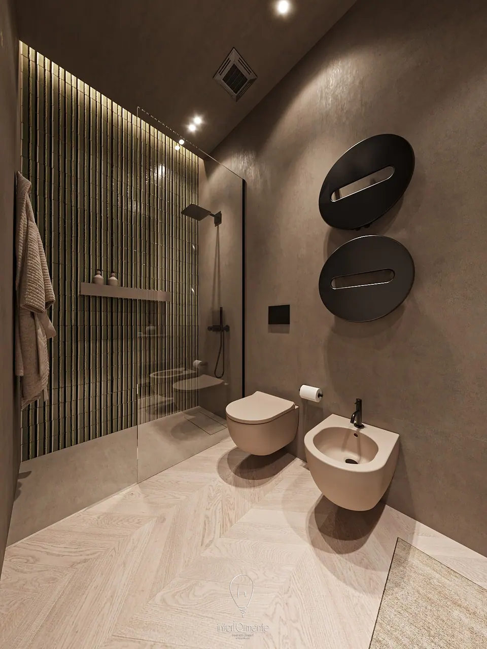 Bagno in resina tortora con doccia a piastrelle verdi verticali, scaldasalviette tondi neri e sanitari sospesi color sabbia