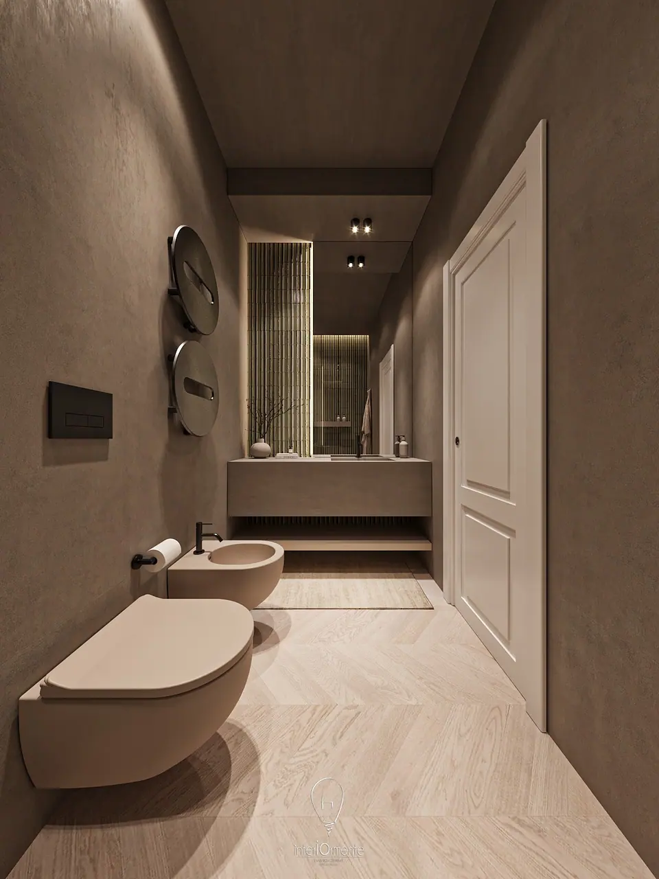 Bagno tortora visto in lunghezza, con sanitari sospesi in primo piano, scaldasalviette tondi e piano lavabo con specchio in fondo