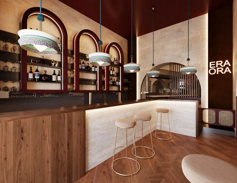 Bar con bancone in legno, nicchie ad arco bordeaux per le bottiglie e sgabelli alti