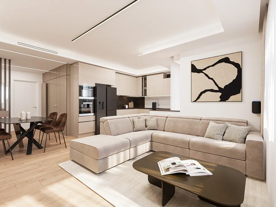 Zona giorno con divano color sabbia, tavolini bassi e cucina sullo sfondo